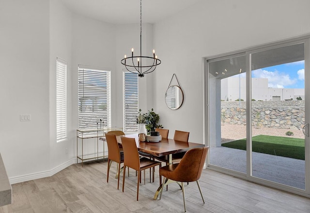 dining area with an inviting chandelier, light hardwood / wood-style floors, and a wealth of natural light