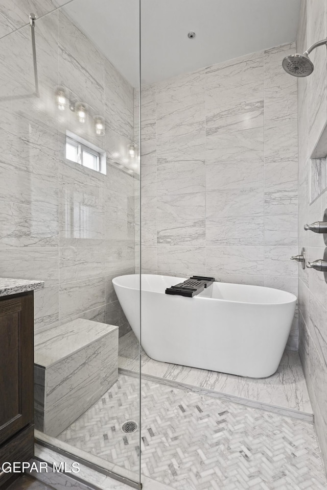 bathroom with plus walk in shower and tile walls