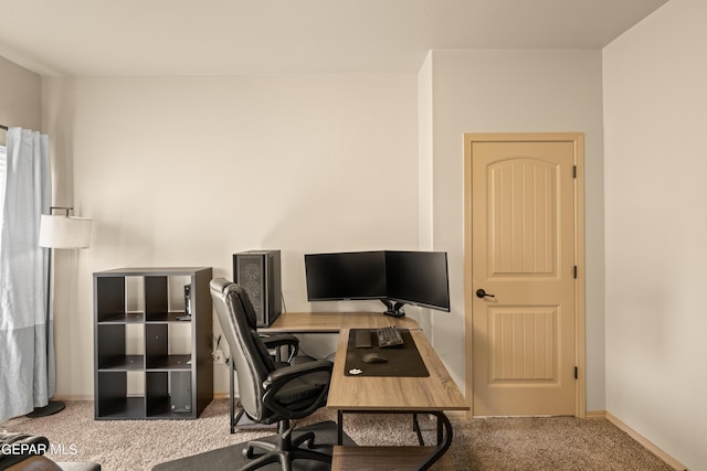 carpeted office featuring baseboards