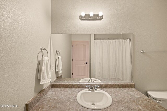 bathroom featuring sink and toilet