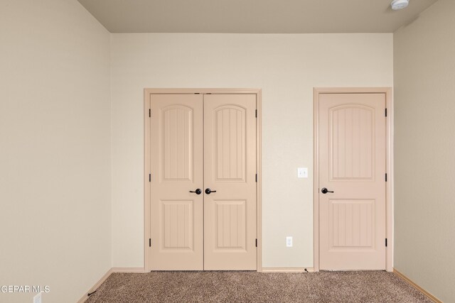 unfurnished bedroom with a closet and carpet flooring