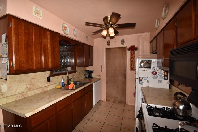 kitchen featuring ceiling fan, dishwasher, backsplash, light tile floors, and sink