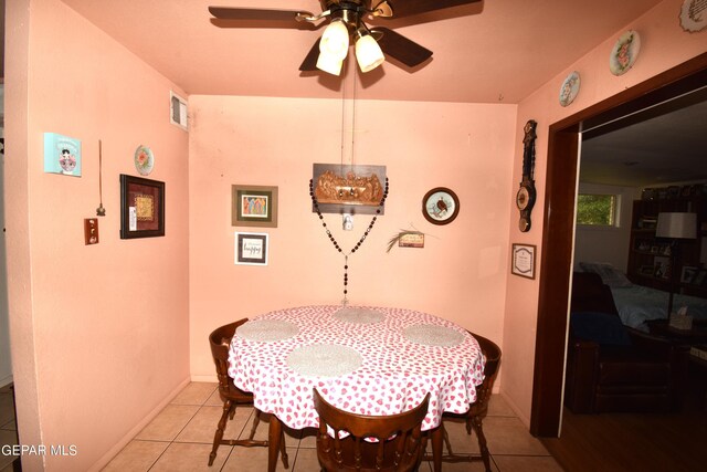 tiled dining space featuring ceiling fan