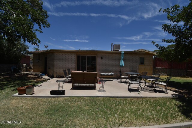 back of property with a patio and a lawn