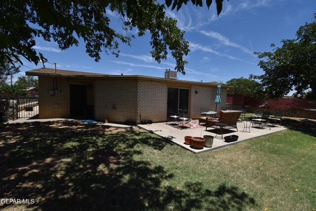 rear view of property with a patio area, central air condition unit, and a lawn