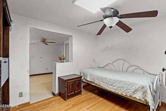 bedroom with ceiling fan and light hardwood / wood-style flooring