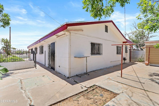 view of property exterior featuring a patio area