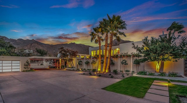 view of front of property with a mountain view and a garage