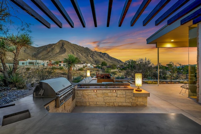 928 Singing Hills Dr, El Paso, TX 79912 - view of patio with grilling area, a mountain view, an outdoor kitchen, and an outdoor fire pit