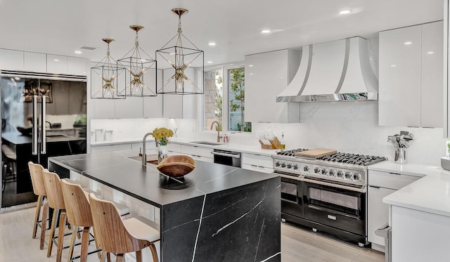 928 Singing Hills Dr, El Paso, TX 79912 - kitchen with custom exhaust hood, a sink, modern cabinets, range with two ovens, and freestanding refrigerator
