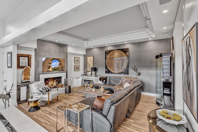 928 Singing Hills Dr, El Paso, TX 79912 - living room featuring recessed lighting, light wood-style floors, a tray ceiling, and a fireplace