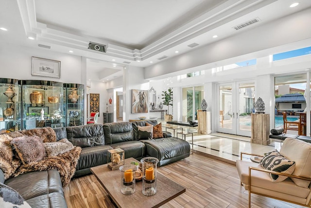 928 Singing Hills Dr, El Paso, TX 79912 - living room featuring light wood-style floors, visible vents, a high ceiling, and french doors