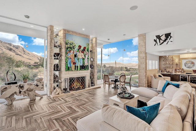 928 Singing Hills Dr, El Paso, TX 79912 - living area with wine cooler, a mountain view, bar, floor to ceiling windows, and a large fireplace