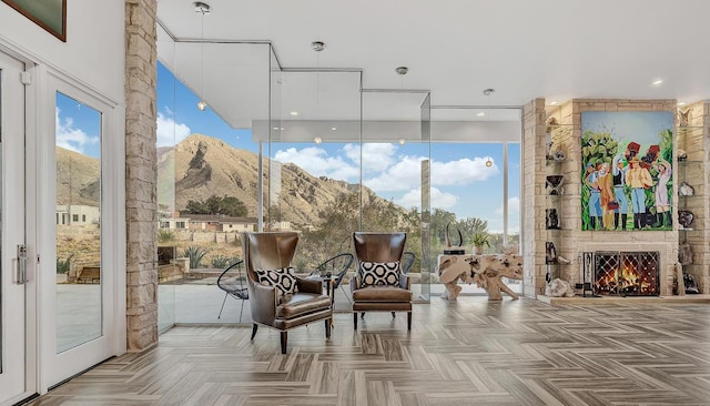 928 Singing Hills Dr, El Paso, TX 79912 - sitting room featuring expansive windows, a mountain view, and a large fireplace