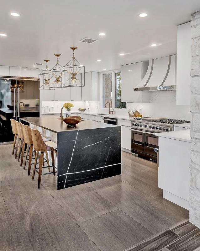928 Singing Hills Dr, El Paso, TX 79912 - kitchen featuring white cabinets, modern cabinets, wall chimney range hood, and range with two ovens