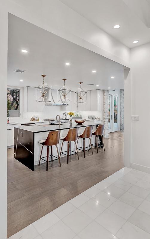 928 Singing Hills Dr, El Paso, TX 79912 - kitchen with a kitchen breakfast bar, a wealth of natural light, and white cabinetry
