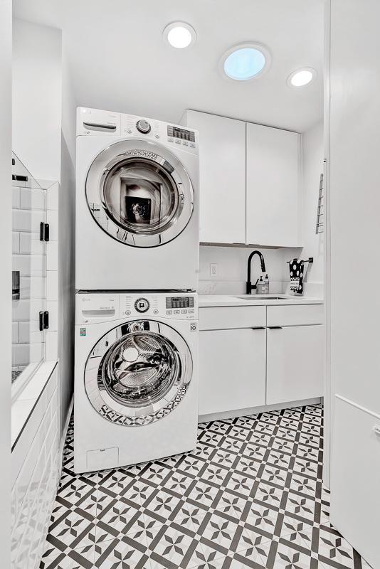 928 Singing Hills Dr, El Paso, TX 79912 - laundry area featuring light floors, cabinet space, stacked washer / dryer, and a sink