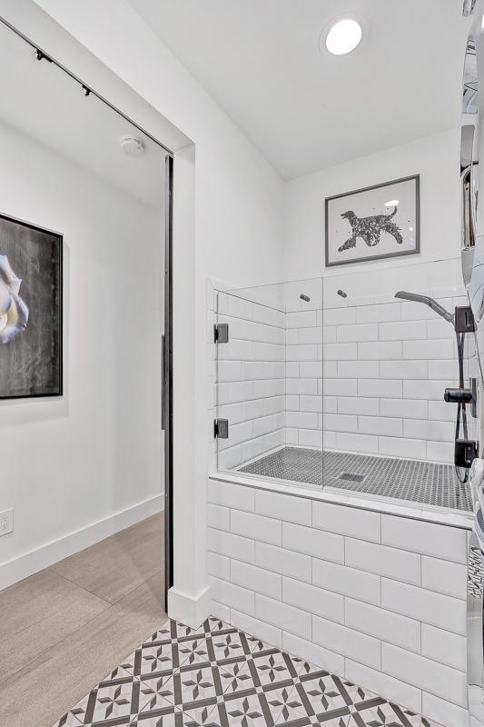 928 Singing Hills Dr, El Paso, TX 79912 - bathroom featuring a tile shower and baseboards