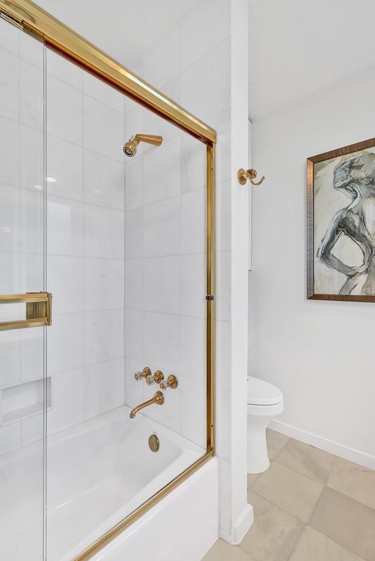 928 Singing Hills Dr, El Paso, TX 79912 - bathroom featuring toilet, baseboards, enclosed tub / shower combo, and tile patterned floors