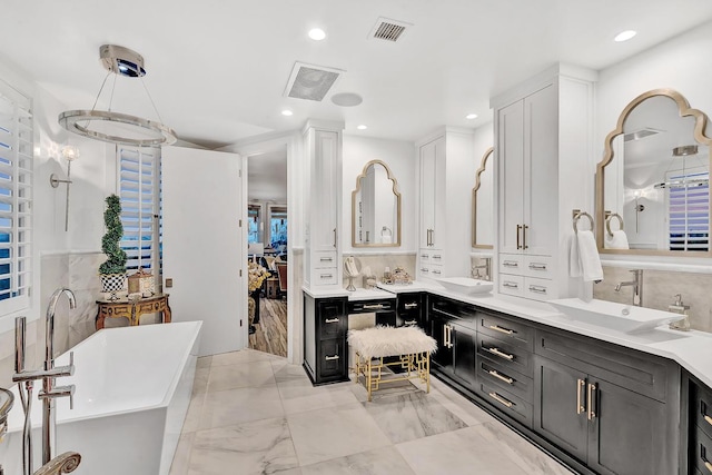 928 Singing Hills Dr, El Paso, TX 79912 - full bathroom with a freestanding bath, a sink, visible vents, and recessed lighting