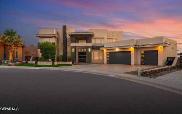 pueblo-style home with a garage