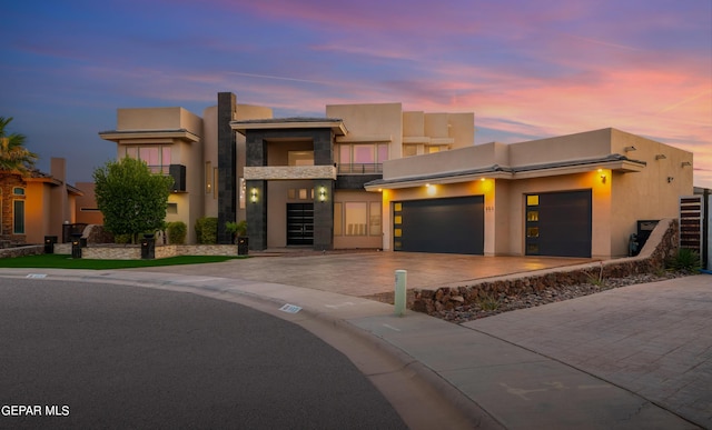 pueblo-style house with a garage