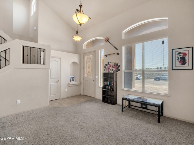 carpeted living room with high vaulted ceiling