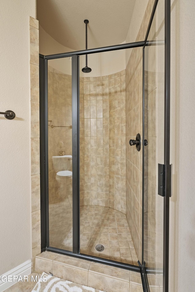 bathroom featuring a shower with door