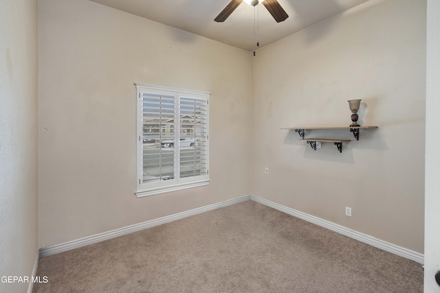 empty room featuring ceiling fan and carpet