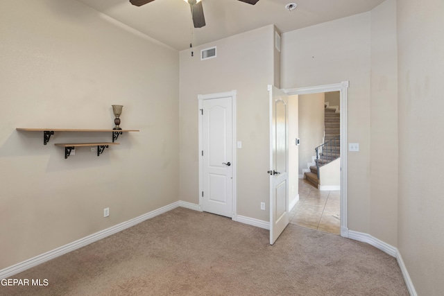 unfurnished bedroom featuring ceiling fan and light colored carpet