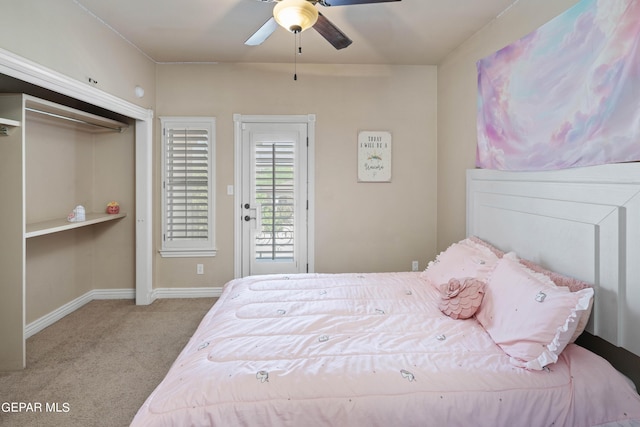 carpeted bedroom with ceiling fan and a closet