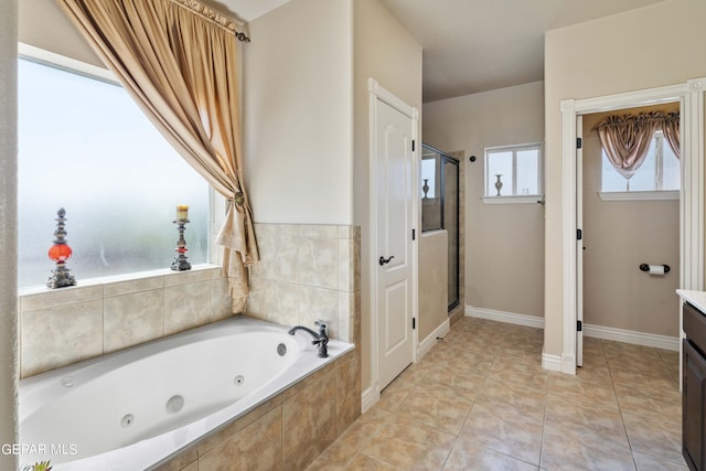 bathroom featuring vanity, tile patterned flooring, and plus walk in shower