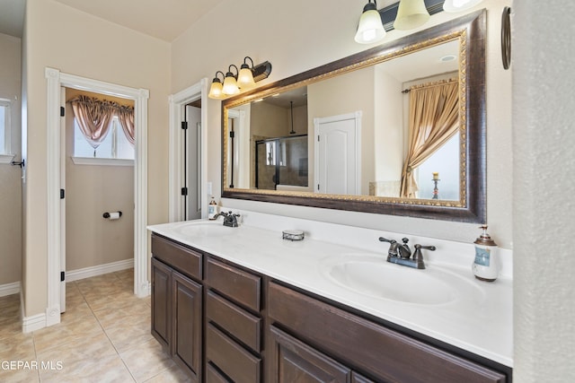 bathroom featuring a shower with shower door, vanity, and tile patterned flooring