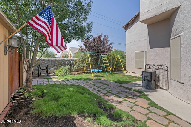 view of yard featuring a playground and a patio area