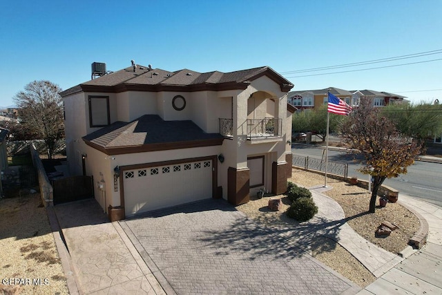 view of front of property featuring a garage and a balcony