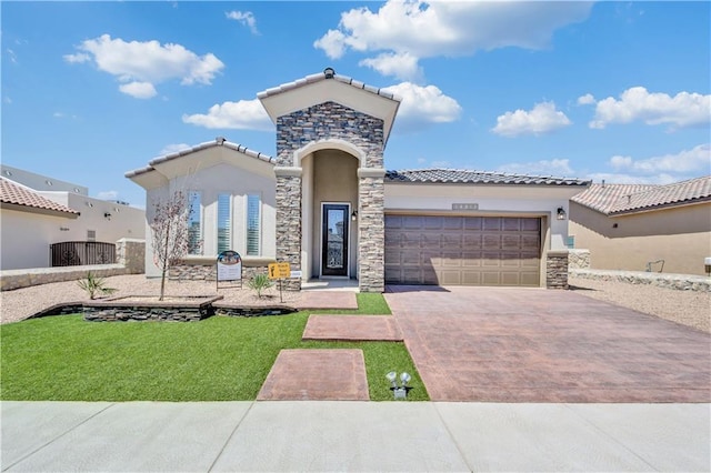 mediterranean / spanish-style house featuring a garage and a front yard