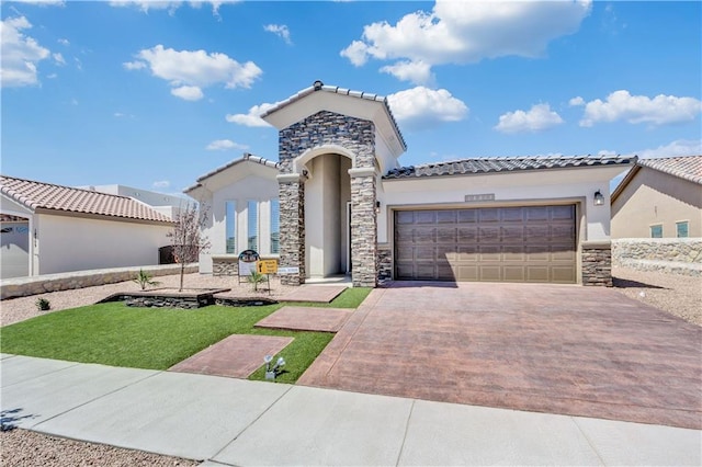 mediterranean / spanish home with a front yard and a garage