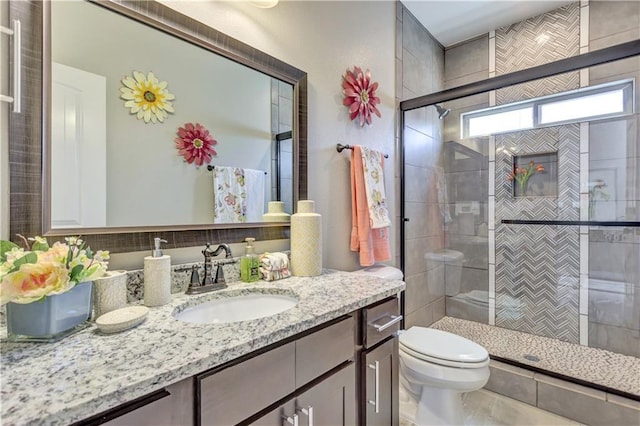 1701 Bull Ring St, El Paso, TX 79928 - bathroom featuring vanity, toilet, and a shower with shower door