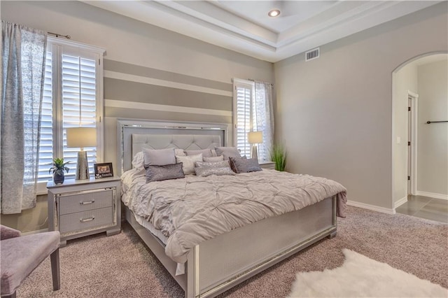 1701 Bull Ring St, El Paso, TX 79928 - bedroom with light carpet, a tray ceiling, and multiple windows
