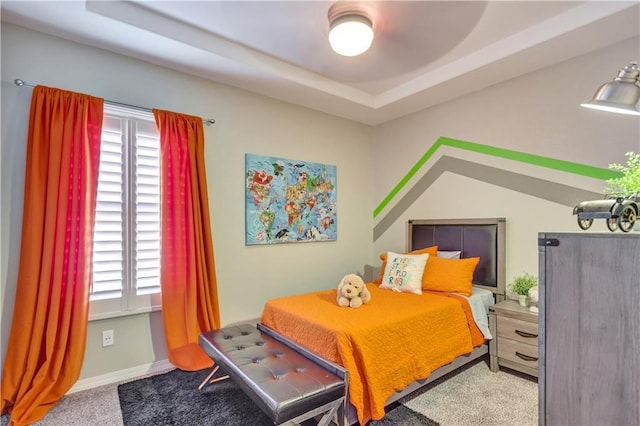 1701 Bull Ring St, El Paso, TX 79928 - bedroom with ceiling fan, light colored carpet, a tray ceiling, and multiple windows