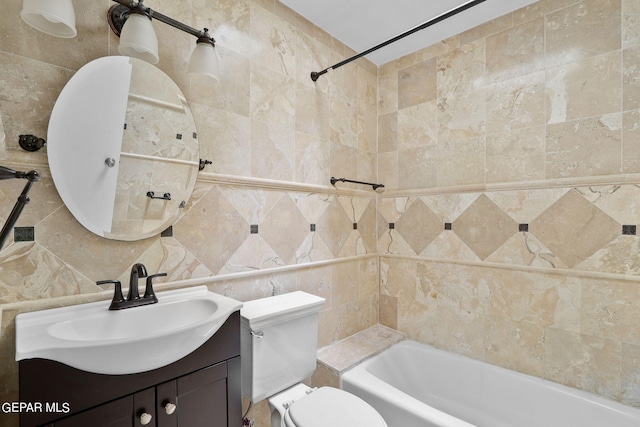 full bathroom with backsplash, toilet, vanity, tile walls, and tiled shower / bath