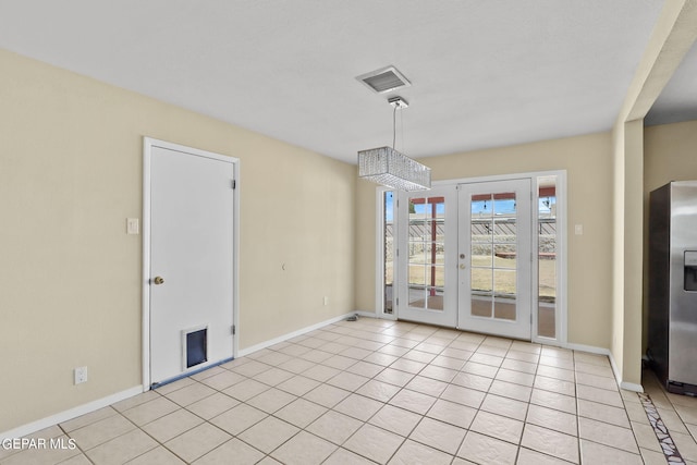 unfurnished dining area featuring light tile patterned floors and french doors