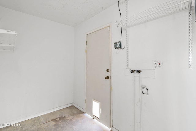 doorway to outside featuring concrete floors