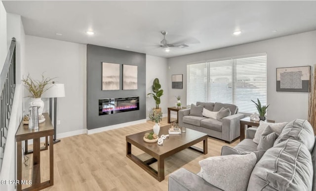 living room with light hardwood / wood-style floors and ceiling fan