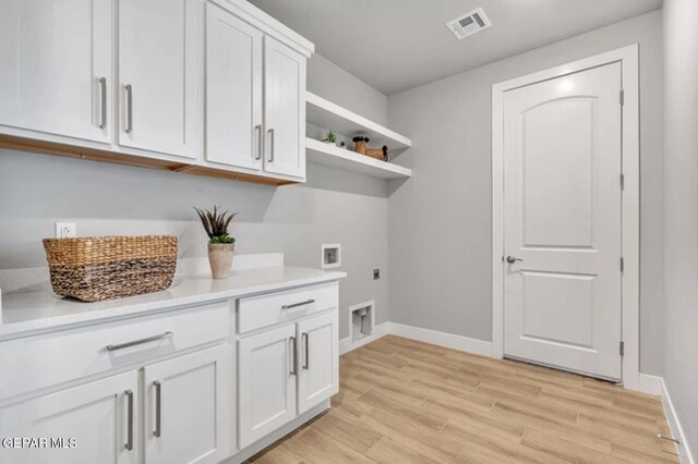 laundry area featuring electric dryer hookup, cabinets, washer hookup, and light hardwood / wood-style floors