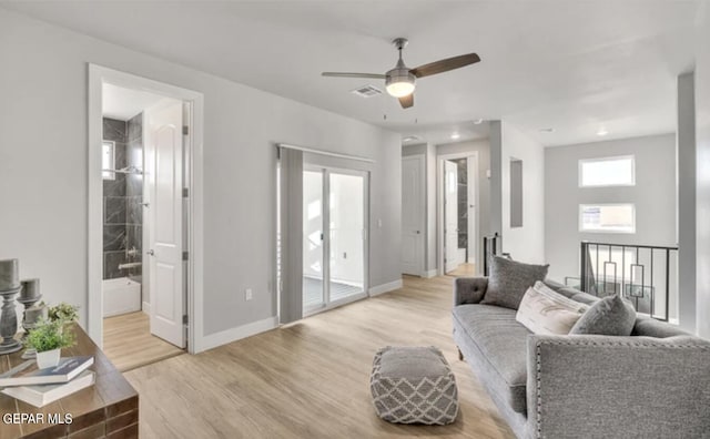 living room featuring ceiling fan and light wood-type flooring