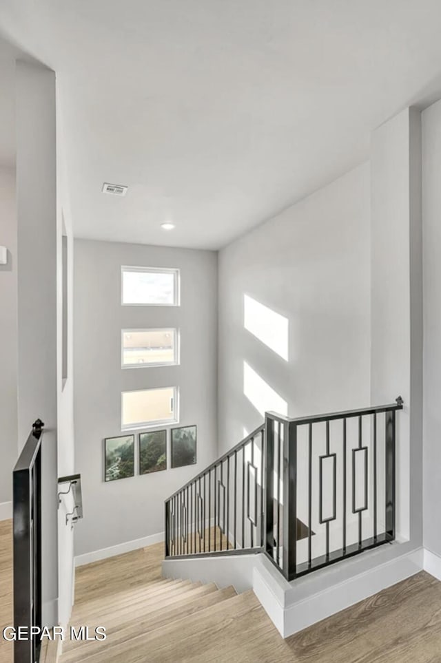 stairway featuring light hardwood / wood-style flooring