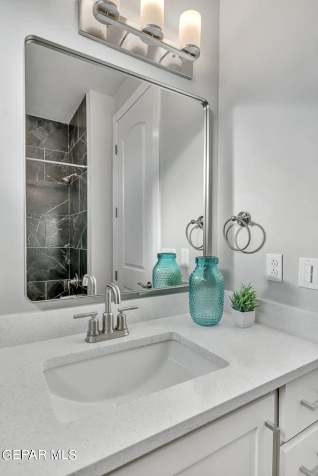 bathroom featuring vanity and a tile shower