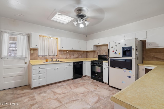 kitchen featuring black appliances, a sink, light countertops, and white cabinets