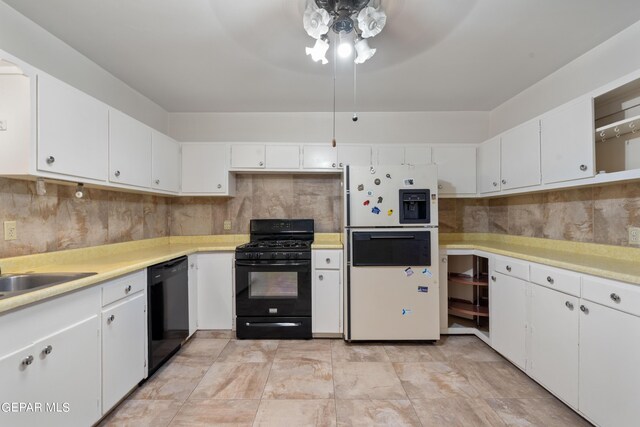 kitchen with black appliances and white cabinetry